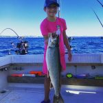 sunny day child holding fish